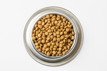 dry pet food in a metal bowl isolated on white background