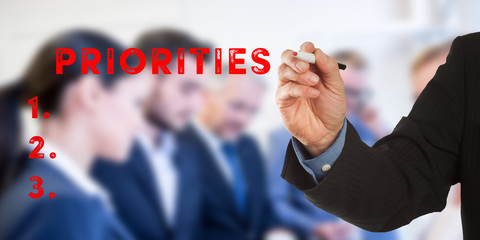 Priorities, Business man hand writing with team