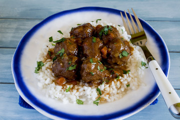 Meatballs with rice and vegetable and tomato sauce