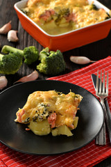 Casserole with fish (salmon), potatoes and broccoli.