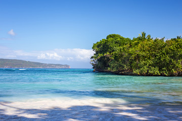 Caribbean landscape with crystal water and green island