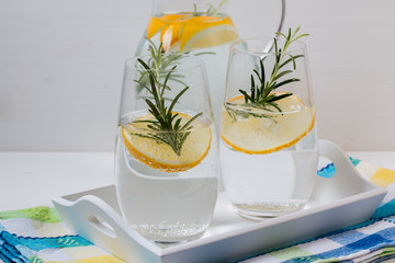Fresh water drink with lemon,rosemary and cucumber. White background.