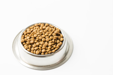 dry pet food in a metal bowl isolated on white background