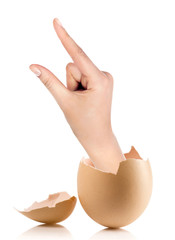 Hand with broken egg isolated on white backround