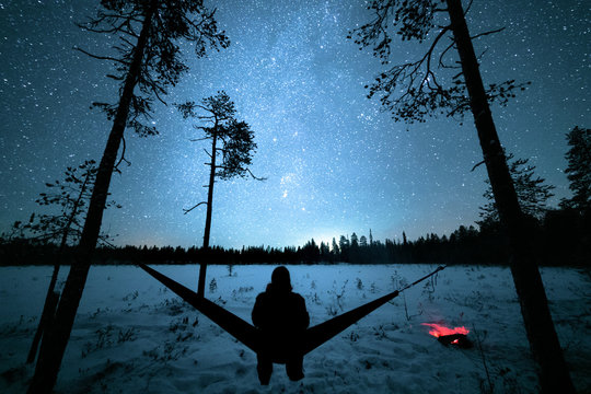 Sitting in hammock under starry sky