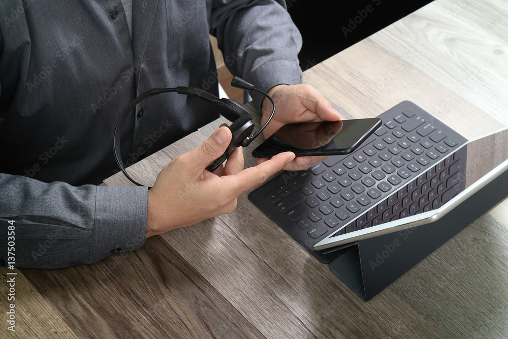 Aufkleber top view of man hand using voip headset with digital tablet computer docking keyboard,smart phone,co