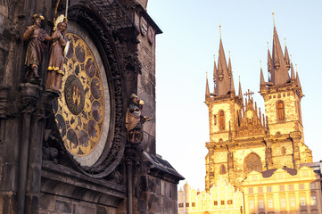 Naklejka premium Prague. Czech Republic. Astronomical clock on Old Town square and Church of Our Lady before Tyn captured at golden hour.