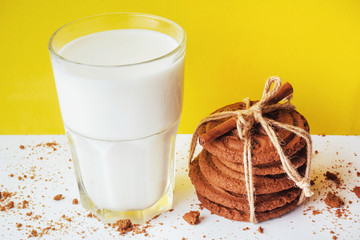 Transparent glass of milk and cookies on a white background