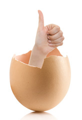 Hand with broken egg isolated on white backround