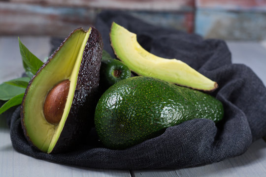 Green ripe avocado with leaves
