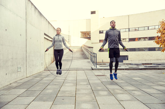 man and woman exercising with jump-rope outdoors