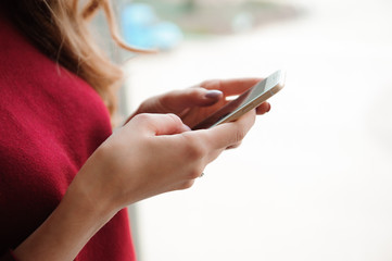 beautiful business woman writing sms on a mobile phone