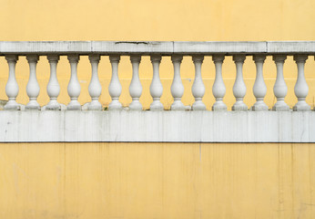 architectural detail / Yellow brick wall with white railing