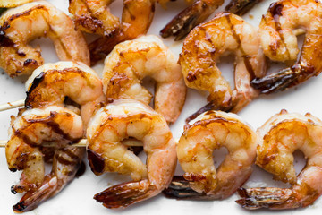 tasty spiced shrimp skewers on a barbecue