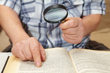 Elderly man reading a book