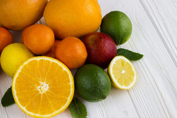 Fototapeta na wymiar Lemon,red orange, orange, grapefruit, lime on old wooden table. Background.