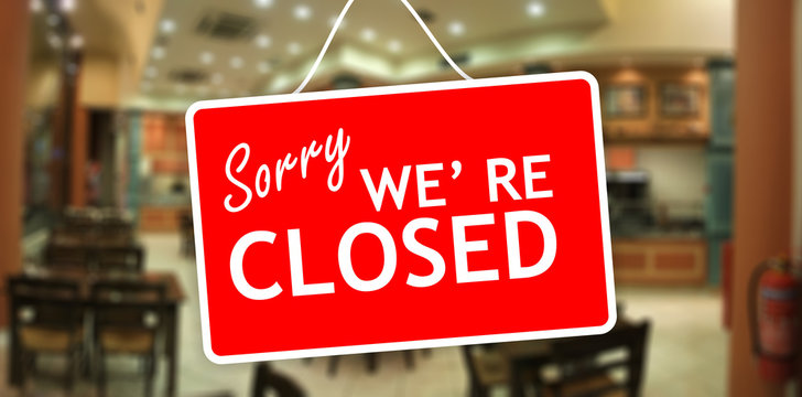 Sorry We Are Closed Sign On Glass Storefront