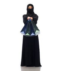 muslim woman in hijab with shopping bags