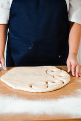 Chef preparing dough - cooking donuts process