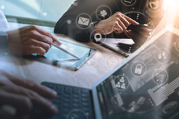 Designer Businessman hand using smart phone,mobile payments online shopping,omni channel,digital tablet docking keyboard computer in modern office on wooden desk,virtual interface icons screen