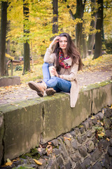 Naklejka na ściany i meble girl sitting on the concrete stone in the Park