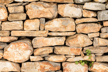 Old vintage hand made rock stone wall texture pattern background
