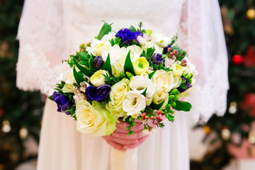 Beautiful wedding bouquet of flowers in brides hands