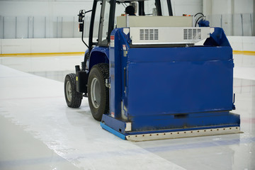 Resurfacing machine cleaning ice of hockey rink. - 137514763