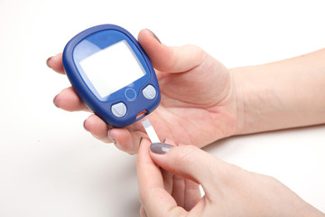 Close-up Of Woman Hands Testing High Blood Sugar With Glucometer