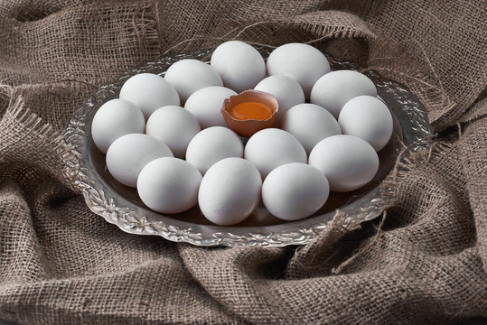 Fresh eggs collected on a tray for cooking on the fabric.