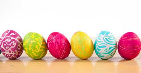 Closeup of beautiful Easter eggs with their hands. A festive mood.

