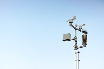 Weather station on blue sky background