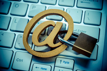 Email sign with a padlock on computer keyboard. Email security and countermeasure concept