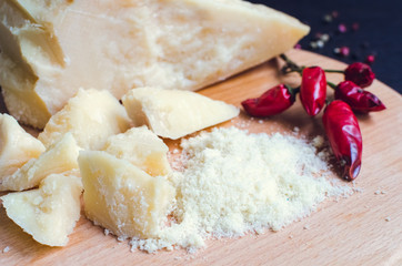 Grated Parmesan cheese on wooden board