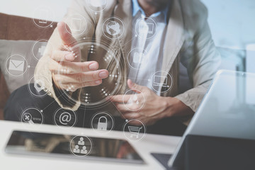 hipster hand using smart phone,digital tablet docking keyboard,coffee cup, payments online business,sitting on sofa in living room,work at home concept