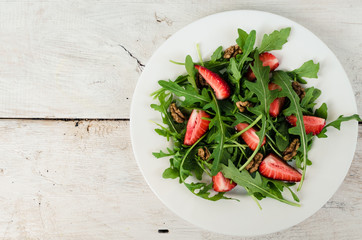 Fresh salad with arugula and strawberries