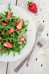 Fresh salad with arugula and strawberries