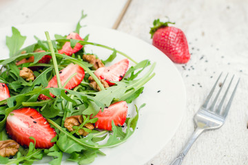Fresh salad with arugula and strawberries