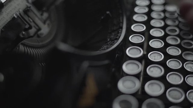 man typing on retro typewriter close up.