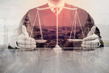 justice and law concept.Male judge in a courtroom with the balance scale on wood table with london...