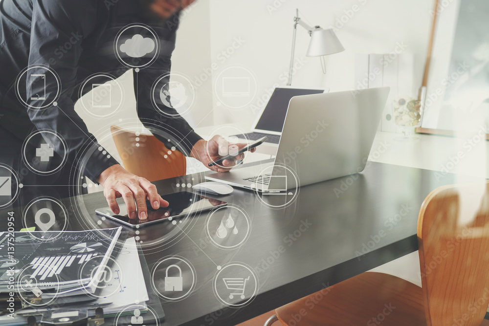 Poster businessman or Designer using smart phone with latop and digital tablet computer and document on desk in modern office with virtual interface graphic icons network diagram
