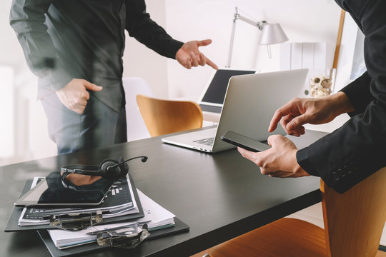 co working meeting,two businessman using VOIP headset with laptop computer on desk in modern office as call center and customer service help desk concept 