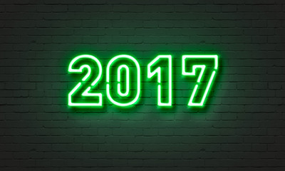 2017 neon sign on brick wall background.