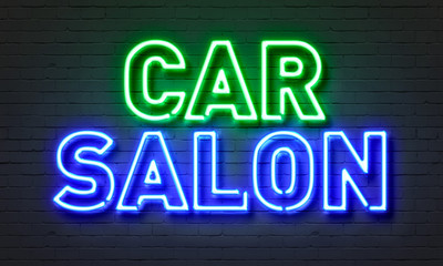 Car salon neon sign on brick wall background.