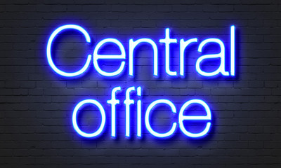 Central office neon sign on brick wall background.