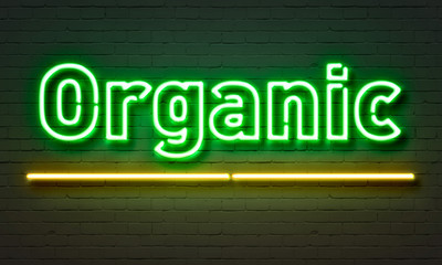 Organic neon sign on brick wall background.