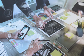Designer and Businessman using smart phone and digital tablet and laptop computer in modern office with virtual screen interface icons diagram as concept