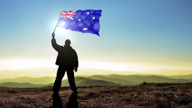 silhouette man waving Australia flag 
