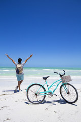 Man with a bike on the beach