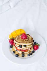 Hotcakes with fruit in bed